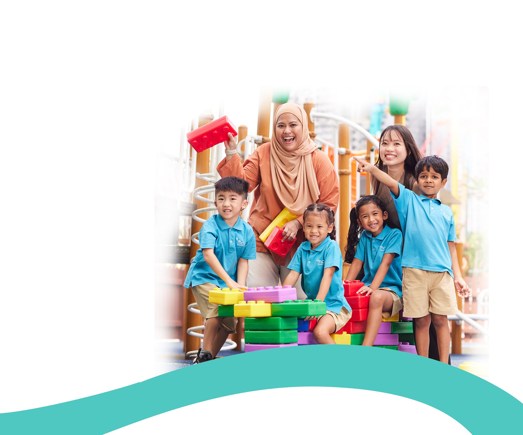 children and teachers at the playground looking happy