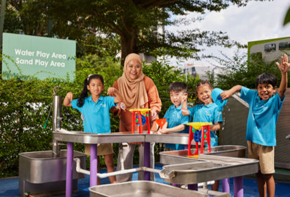A kindergarten teacher engaging with young children